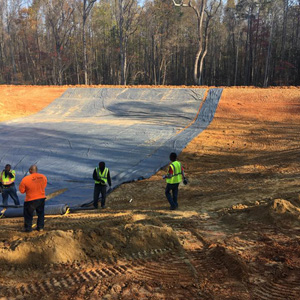 Crews deploying the 30-mil PVC liner.