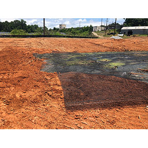 Pond closure - using geogrid to help bridge the pond.